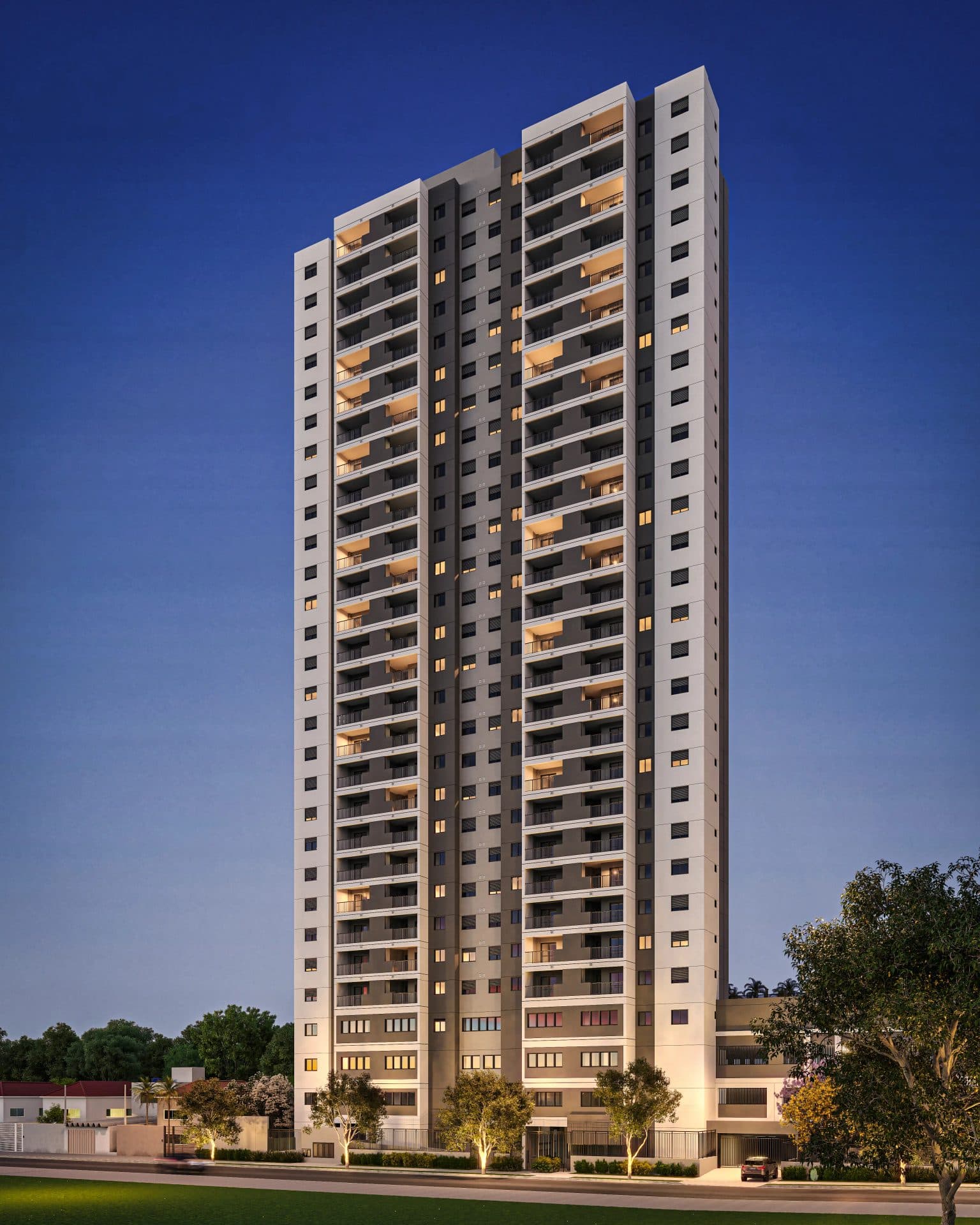 Fachada noturna de edifício residencial alto com varandas iluminadas.