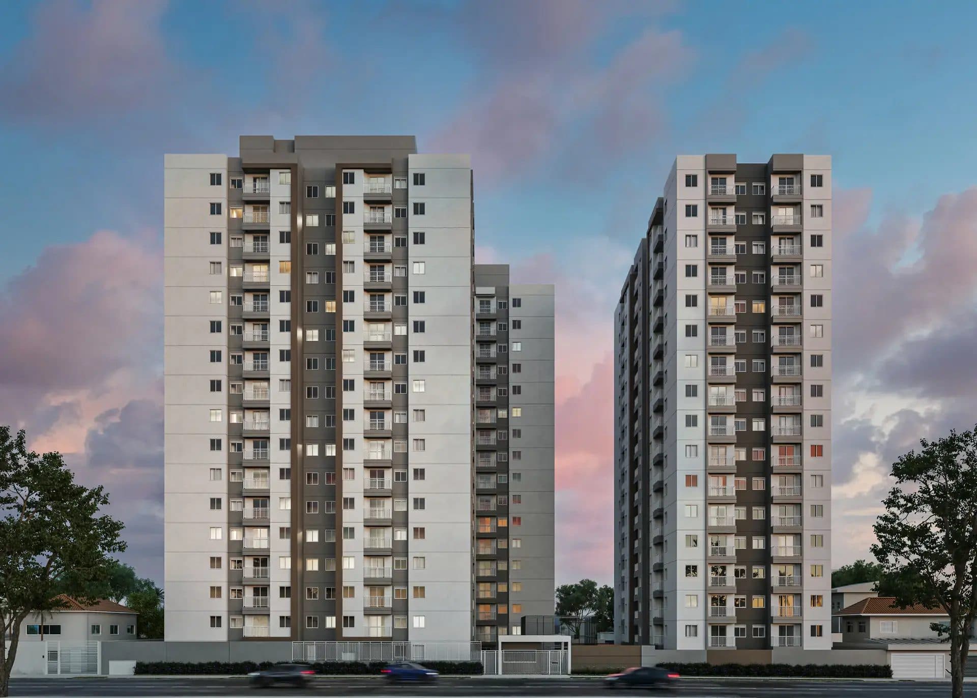 Fachada de torres residenciais com varandas e iluminação noturna.