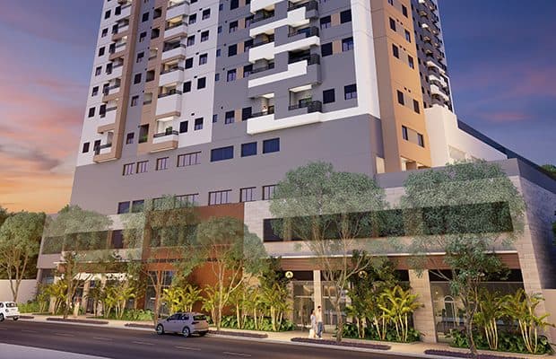 Fachada do edifício com design moderno, varandas e paisagismo na entrada.