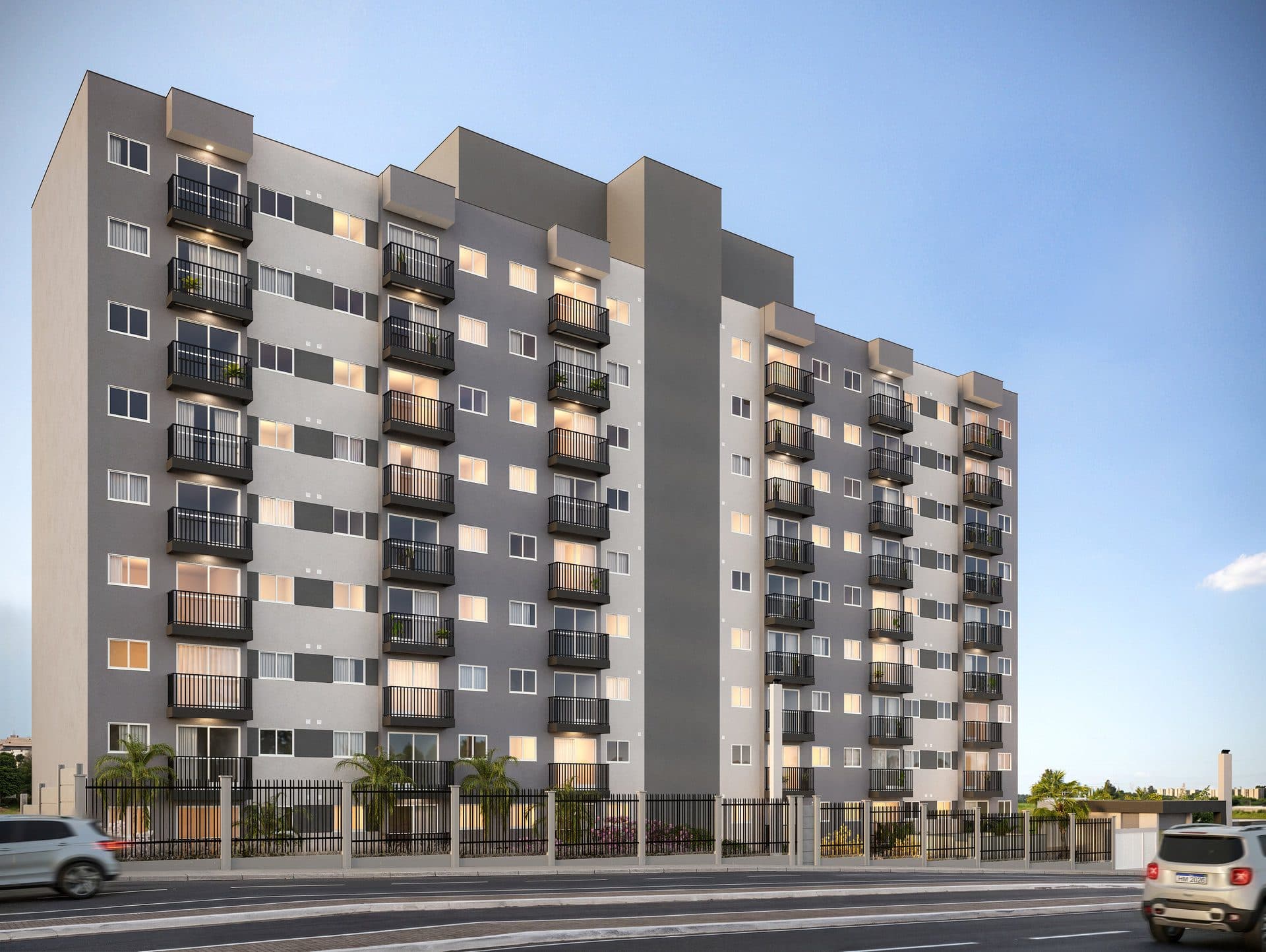 Fachada de edifício residencial com varandas e grade de proteção frontal.
