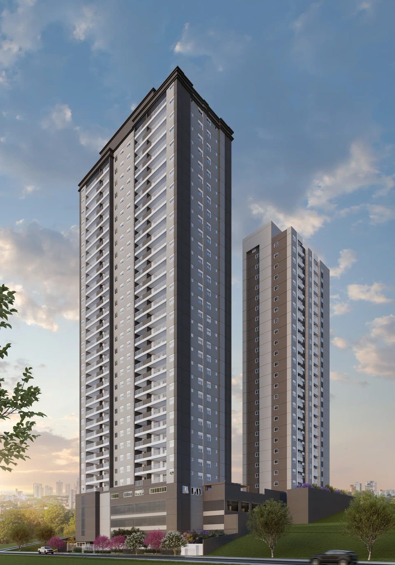 Vista externa de duas torres residenciais altas com varandas, sob um céu azul.
